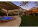 Beautiful backyard featuring a pool, covered patio, and well-maintained landscaping at 7438 Desertscape Ave, Las Vegas, NV 89178