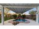 Serene backyard setting with a rock waterfall feature under a stylish covered patio at 7438 Desertscape Ave, Las Vegas, NV 89178