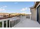 Private balcony with white railings offering peaceful views of the landscaped backyard and neighborhood at 7438 Desertscape Ave, Las Vegas, NV 89178