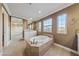 Spacious bathroom featuring a standalone tub, natural light, and dual sink vanities at 7438 Desertscape Ave, Las Vegas, NV 89178