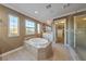 Luxurious bathroom with a standalone tub, glass-enclosed shower, and walk-in closet access at 7438 Desertscape Ave, Las Vegas, NV 89178