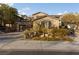 Inviting two-story home featuring a spacious driveway and a well-manicured desert landscape at 7438 Desertscape Ave, Las Vegas, NV 89178
