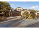 Inviting two-story home featuring a spacious driveway and a well-manicured desert landscape at 7438 Desertscape Ave, Las Vegas, NV 89178