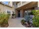 Welcoming front entrance featuring a brick facade, well-placed plants, and a lovely wreath on the door at 7438 Desertscape Ave, Las Vegas, NV 89178