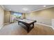 Bright game room featuring a beautiful pool table and plush carpeting for comfortable play at 7438 Desertscape Ave, Las Vegas, NV 89178