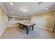 Spacious game room with a pool table, neutral walls, and cozy carpet flooring at 7438 Desertscape Ave, Las Vegas, NV 89178