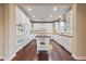 Spacious kitchen featuring white cabinets, hardwood floors, stainless appliances, and center island at 7438 Desertscape Ave, Las Vegas, NV 89178