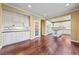 Bright kitchen with white cabinetry, kitchen island, stainless appliances, and hardwood floors at 7438 Desertscape Ave, Las Vegas, NV 89178