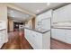 Well-designed kitchen with large island, stainless appliances, white cabinets, and granite countertops at 7438 Desertscape Ave, Las Vegas, NV 89178