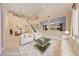 Bright, open-concept living room featuring a staircase, dining area, and modern furnishings at 7438 Desertscape Ave, Las Vegas, NV 89178