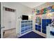 ' bedroom featuring themed decorations, storage units, and a view into the laundry room at 76 Summer Rhapsody Ave, Henderson, NV 89015