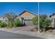 Cozy single-story home featuring a two-car garage, desert landscaping, and a brick driveway at 76 Summer Rhapsody Ave, Henderson, NV 89015