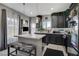 Well-lit kitchen featuring a quartz island, contemporary pendant lights, and dark cabinetry at 76 Summer Rhapsody Ave, Henderson, NV 89015
