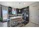 Charming kitchen features dark cabinets, quartz countertops, and stainless steel appliances at 76 Summer Rhapsody Ave, Henderson, NV 89015
