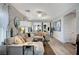 Bright living room featuring modern decor, comfortable seating, and views into the dining area at 76 Summer Rhapsody Ave, Henderson, NV 89015