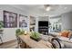 Cozy living room featuring stylish decor, comfortable seating, and a seamless flow into dining area at 76 Summer Rhapsody Ave, Henderson, NV 89015