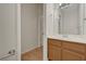 Bathroom vanity with single sink, wood cabinet and mirror at 8040 Tailwind Ave, Las Vegas, NV 89131