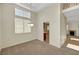 Elegant dining room with natural light, plush carpeting, and convenient access to the kitchen, ideal for entertaining at 8040 Tailwind Ave, Las Vegas, NV 89131