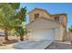 Charming two-story home featuring a well-maintained lawn, mature trees, and a two-car garage, offering curb appeal and convenience at 8040 Tailwind Ave, Las Vegas, NV 89131