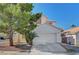 Charming two-story home featuring a well-maintained lawn, mature trees, and a two-car garage, offering curb appeal and convenience at 8040 Tailwind Ave, Las Vegas, NV 89131