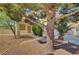 Inviting front yard featuring mature trees and attractive landscaping, providing shade and curb appeal to the property at 8040 Tailwind Ave, Las Vegas, NV 89131
