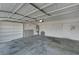 Spacious garage with built-in shelving, water heater, and concrete flooring at 8040 Tailwind Ave, Las Vegas, NV 89131