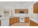 Well-lit kitchen boasts white appliances, tile floors, and ample counter space at 8040 Tailwind Ave, Las Vegas, NV 89131