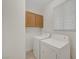 Functional laundry room with a washer and dryer, cabinet space and natural light at 8040 Tailwind Ave, Las Vegas, NV 89131