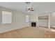 Inviting living room featuring a cozy fireplace and neutral carpet flooring at 8040 Tailwind Ave, Las Vegas, NV 89131