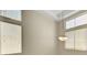 Bright living room with tall windows, providing ample natural light and a view of the outdoors with a modern light fixture at 8040 Tailwind Ave, Las Vegas, NV 89131