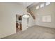 Bright living room with plush carpet and stairs, offering seamless transition to the kitchen and upper floors at 8040 Tailwind Ave, Las Vegas, NV 89131