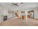 Open-concept layout with fireplace, stairs, and modern kitchen featuring stainless steel appliances at 8040 Tailwind Ave, Las Vegas, NV 89131