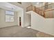 Spacious living room featuring plush carpeting, a vaulted ceiling, and a staircase leading to the second floor at 8040 Tailwind Ave, Las Vegas, NV 89131