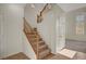 Elegant staircase with wooden railing and tile flooring at the base at 8040 Tailwind Ave, Las Vegas, NV 89131