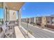 Spacious balcony with a seating area overlooking neighborhood homes on a sunny day at 8092 Haywood Estate Ave, Las Vegas, NV 89113