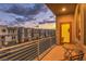 Relax on this balcony with table and chairs enjoying neighborhood views during beautiful sunset skies at 8092 Haywood Estate Ave, Las Vegas, NV 89113