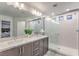 Bright Primary bathroom with double sink vanity, granite counter, and glass shower at 8092 Haywood Estate Ave, Las Vegas, NV 89113