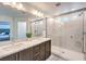 Modern bathroom with a dual vanity, frameless glass shower, and sleek fixtures, providing a spa-like experience at 8092 Haywood Estate Ave, Las Vegas, NV 89113