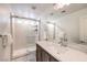 Modern bathroom with a glass enclosed shower, stone countertop and sleek fixtures at 8092 Haywood Estate Ave, Las Vegas, NV 89113