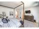 Relaxing bedroom with a four-poster bed, soft carpeting, and modern decor, designed for comfort and style at 8092 Haywood Estate Ave, Las Vegas, NV 89113