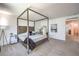 Comfortable bedroom with a stylish four-poster bed, soft carpet, and ample natural light, creating a cozy retreat at 8092 Haywood Estate Ave, Las Vegas, NV 89113