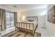 Bright bedroom with sliding glass door and a decorative metal bed frame at 8092 Haywood Estate Ave, Las Vegas, NV 89113