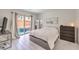 Cozy bedroom with a view to the hot tub, featuring minimalist decor and sliding glass door at 8092 Haywood Estate Ave, Las Vegas, NV 89113