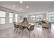 Bright and airy dining area with sleek table set, modern tile flooring, and abundant natural light at 8092 Haywood Estate Ave, Las Vegas, NV 89113