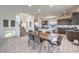 Open-concept dining and kitchen area with modern tile flooring and stainless steel appliances create an inviting and spacious atmosphere at 8092 Haywood Estate Ave, Las Vegas, NV 89113