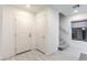 Bright entryway features ceramic tile flooring, staircase, and two storage closets with white doors at 8092 Haywood Estate Ave, Las Vegas, NV 89113