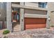 Close-up of a charming three-story home with a brick driveway and brown garage door at 8092 Haywood Estate Ave, Las Vegas, NV 89113