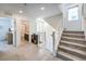 Bright hallway with stairs, neutral carpet, and views into the office and bathroom at 8092 Haywood Estate Ave, Las Vegas, NV 89113