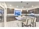 Contemporary kitchen featuring granite countertops, stainless steel appliances, and an island with barstool seating at 8092 Haywood Estate Ave, Las Vegas, NV 89113