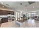 Open-concept kitchen and living area with a large island, stainless steel appliances, and plenty of natural light at 8092 Haywood Estate Ave, Las Vegas, NV 89113